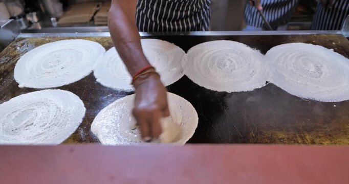 Professional South Indian Chef Preparing Crispy Masala Dosa on Hot Tawa in Busy Indian Restaurant Kitchen, Authentic Street Food Cooking, 4K