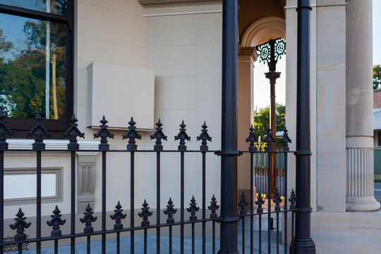 Wrought iron railing fence around old restored historic building