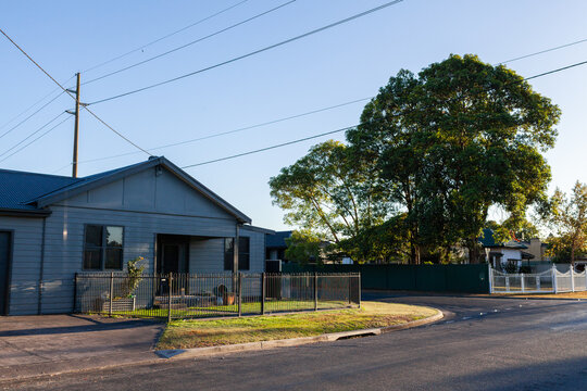 house in country town on corner of streets in morning light