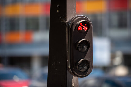 Close-up of illuminated red bicycle traffic signal in a junction in Paris, France.