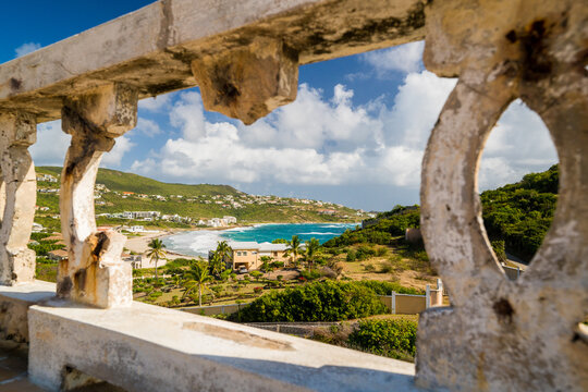 Crumbling stone balcony overlooking a tropical bay