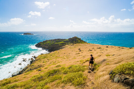 Woman hiking on a scenic coastal trail