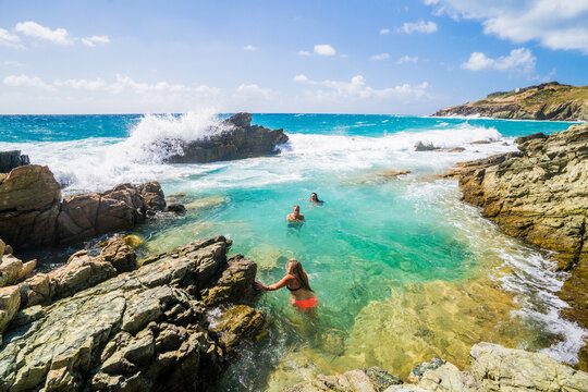 Friends swimming in beautiful turquoise ocean water