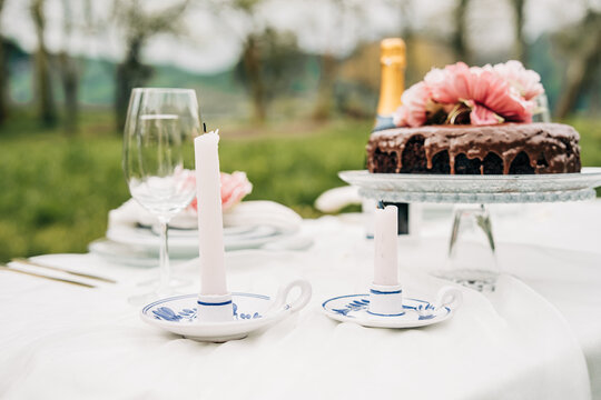 Outdoor dining table setting with cake and candles