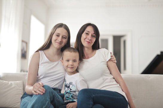 Happy mother posing with her teenage daughter and son