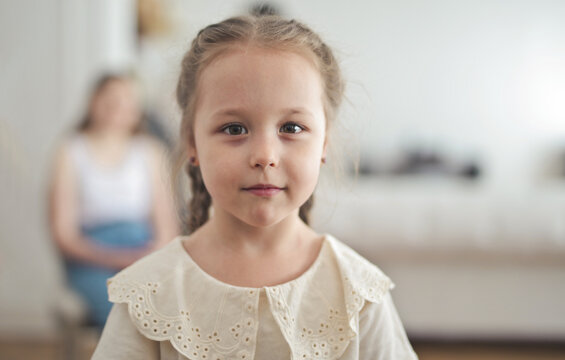 Little girl with braided hair looking at camera