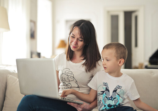 Mother and son looking at laptop computer together