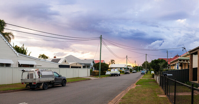 Dramatic clouds in sky with above houses along residential road in country town of Singleton