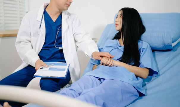 Patient reviewing and signing medical consent documents with healthcare staff during hospital registration, consultation, treatment preparation and care.