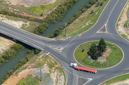 Roundabout and bridge crossing narrow waterway with truck