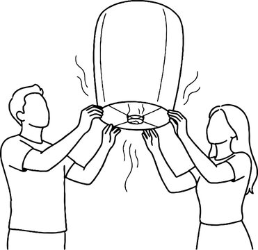 Couple holding and lighting a sky lantern together.