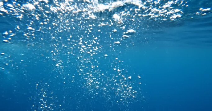 Underwater Bubbles Rising in Ocean Water.