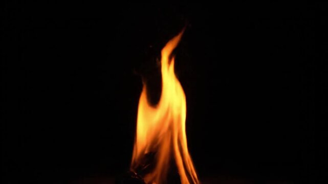 Vibrant orange flames rising against a dark background with warm glowing light