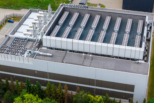 Aerial view of a large hyperscale data center featuring numerous rooftop cooling units and industrial HVAC systems situated in Warsaw, Masovian Voivodeship, Poland.