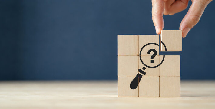 Problems and root cause analysis concept. Define problems to find solution. The wooden cubes with illustration magnifying glass to analyze question mark sign on grey background and copy space.