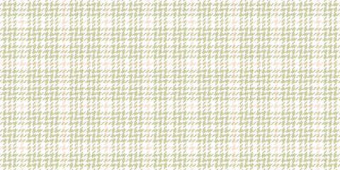 A seamless jacquard fabric for suits and dresses with a subtle olive houndstooth pattern complemented by a delicate pink checkered pattern on a white background. Abstract texture. © Катерина S