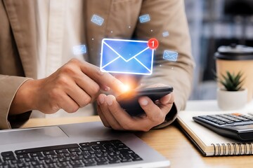 Fototapeta premium Professional individual checks an important email notification on a smartphone with an email icon glowing above their hand in a modern office setting