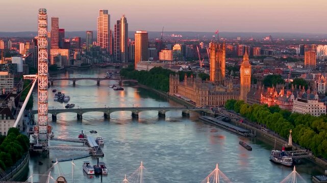 Panoramic aerial view of the skyline of London with Southbank and Embankment, Westminster Palace back to Nine Elms during a golden sunrise
