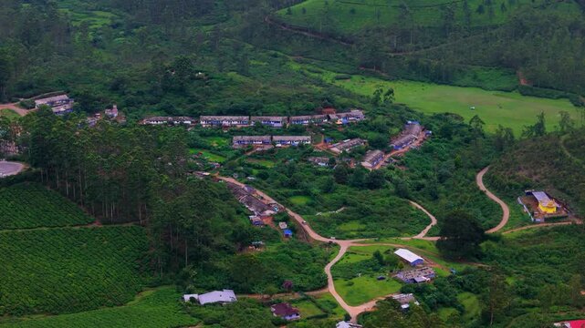 Scenic Aerial View of Small Road Passing Through Munnar Village with Green Mountain Landscape, Tea Plantations, Rural Homes, Misty Hills, Kerala Countryside and Peaceful Natural Scenery