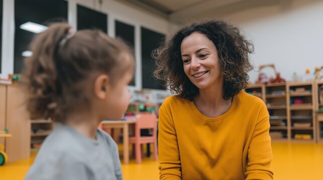 Female teacher engaging with child in bright kindergarten classroom, fostering early education and development program