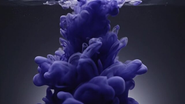 Dark blue ink cloud swirling in clear water.