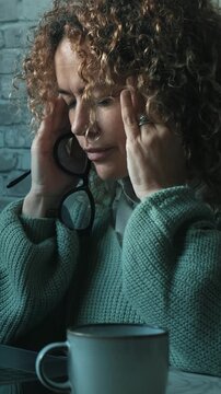 One woman alone having a break in job laptop leisure work for headache and touch her front with hands. Chronic migraine. Overwork on laptop looking monitor illness. Painful bad health condition lady