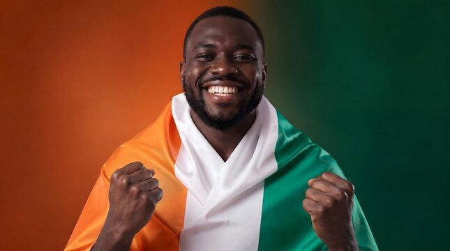 Ivory Coast fan, man and flag celebrating victory with happiness, national pride and success. African person, sports supporter and cheering for team with joy, excitement and patriotic spirit now.