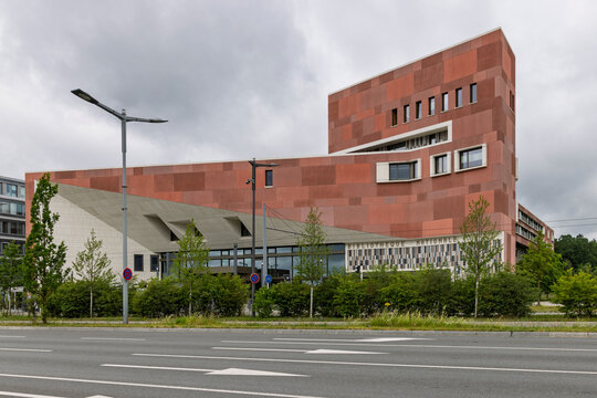 Luxembourg City, Luxembourg - June 5, 2026: The modern red-brick facade of the National Library of Luxembourg building under a cloudy sky.