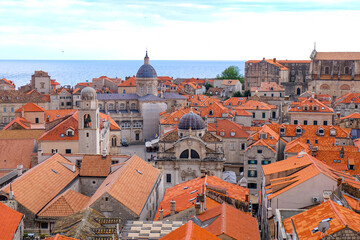 Obraz premium Aerial and above view of Dubrovnik old town, red and orange tile roof and walking the city wall around the old town on a sunset beautiful time, Croatia 