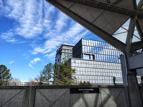 Washington, DC, USA - March 3, 2025: A view through a concrete barrier at office buildings from the ground platform of the Wiehle-Reston East Metrorail station in Virginia