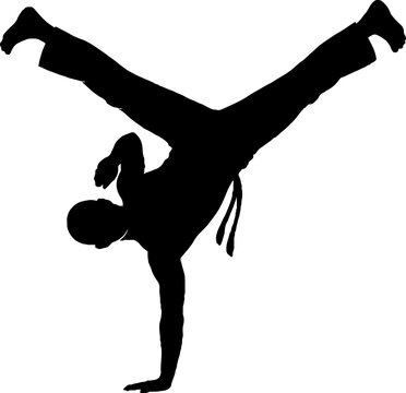 Silhouette of person performing breakdance handstand move.
