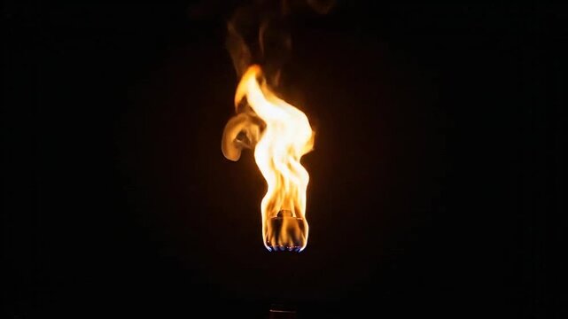 A bright orange flame burning intensely against a solid black background