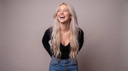 Fototapeta premium Joyful Young Woman Laughing Against Neutral Background