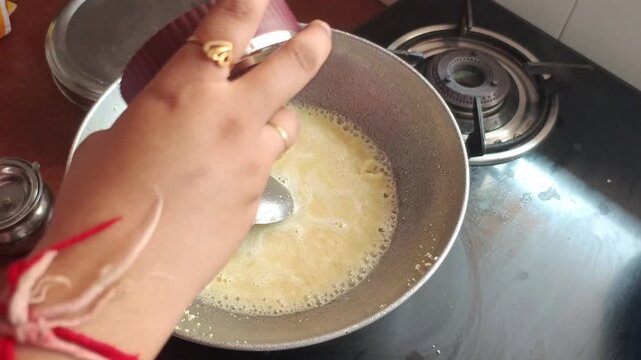 Traditional Indian Semolina Halwa Cooking in Pan on Gas Stove, Homemade Sweet Dessert Preparation