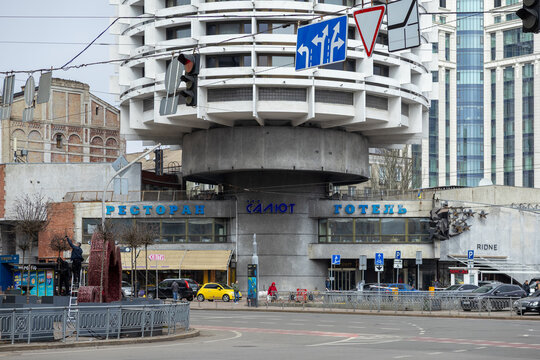 Kyiv, Ukraine - March 22, 2026: Salyut Hotel featuring unique Soviet modernist architecture stands as a landmark in a busy urban intersection during a grey afternoon in the city center