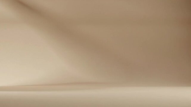 Abstract light and shadow play on a muted studio backdrop creating depth and mood
