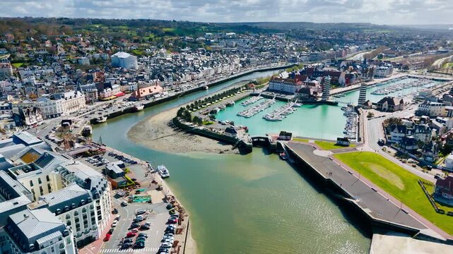 Aerial view of Trouville-Deauville urban landscape with resort buildings, riverfront streets and coastal town atmosphere in Normandy