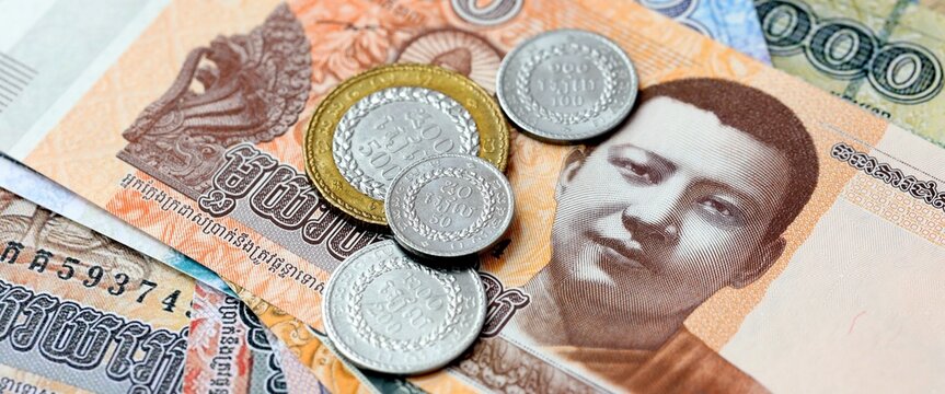 Cambodian riel money bills and coins on table. Cambodia cash of KHR currency