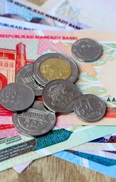 Uzbekistani som money bills and coins on table. Uzbekistan cash of UZS currency close up
