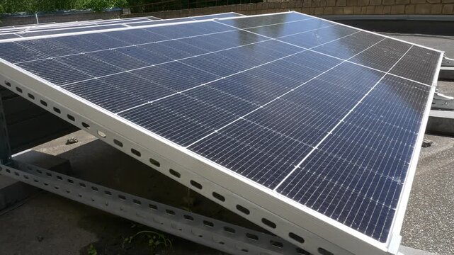 The Concept of Green Energy in an Urban Environment. Solar panels on the roofs of old apartment buildings. A rooftop solar power plant.