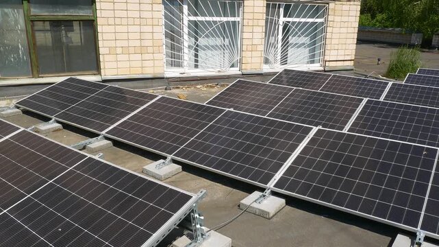 The Concept of Green Energy in an Urban Environment. Solar panels on the roofs of old apartment buildings. A rooftop solar power plant.