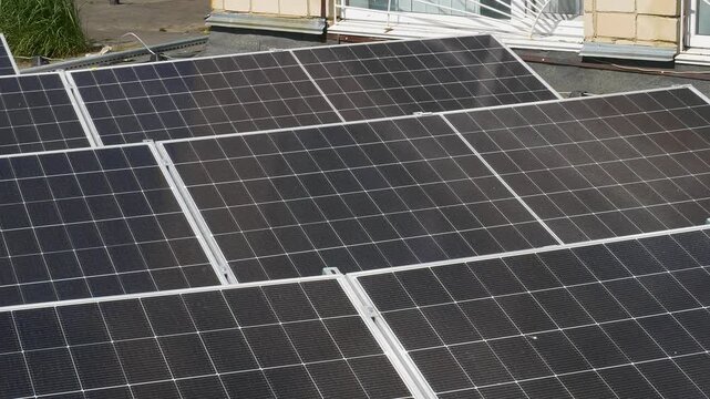 The Concept of Green Energy in an Urban Environment. Solar panels on the roofs of old apartment buildings. A rooftop solar power plant.