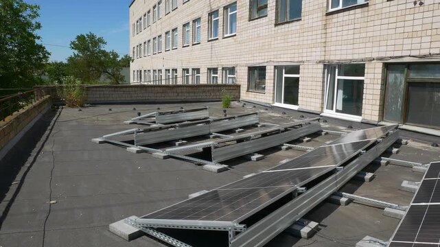 The Concept of Green Energy in an Urban Environment. Solar panels on the roofs of old apartment buildings. A rooftop solar power plant.
