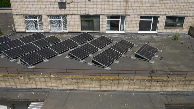 The Concept of Green Energy in an Urban Environment. Solar panels on the roofs of old apartment buildings. A rooftop solar power plant.