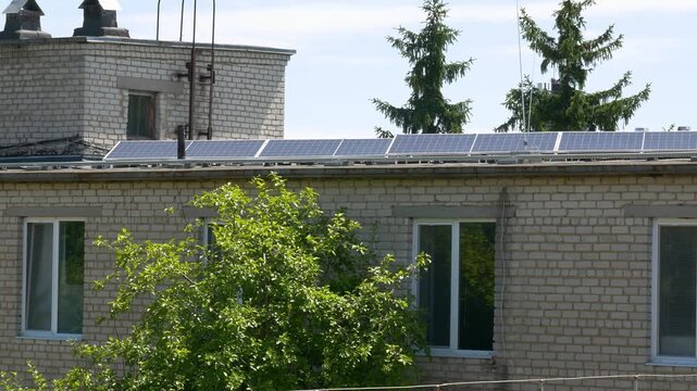 The Concept of Green Energy in an Urban Environment. Solar panels on the roofs of old apartment buildings. A rooftop solar power plant.