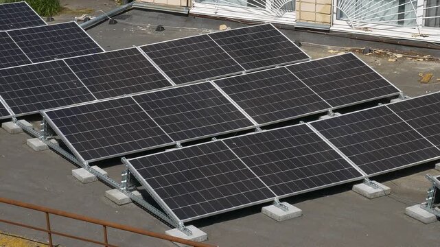 The Concept of Green Energy in an Urban Environment. Solar panels on the roofs of old apartment buildings. A rooftop solar power plant.