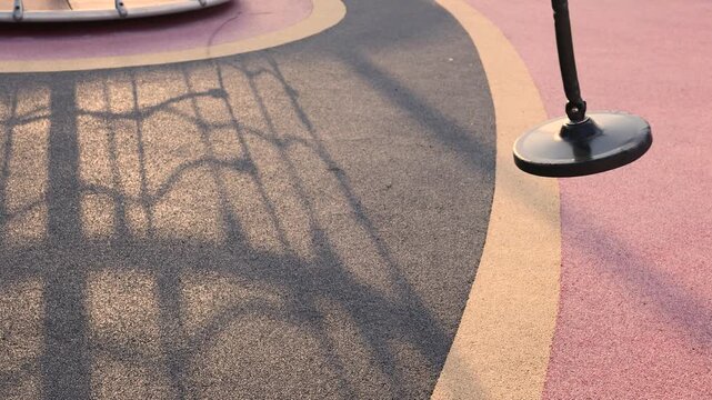 Round nest swing on sunny playground with empty seat and outdoor recreation