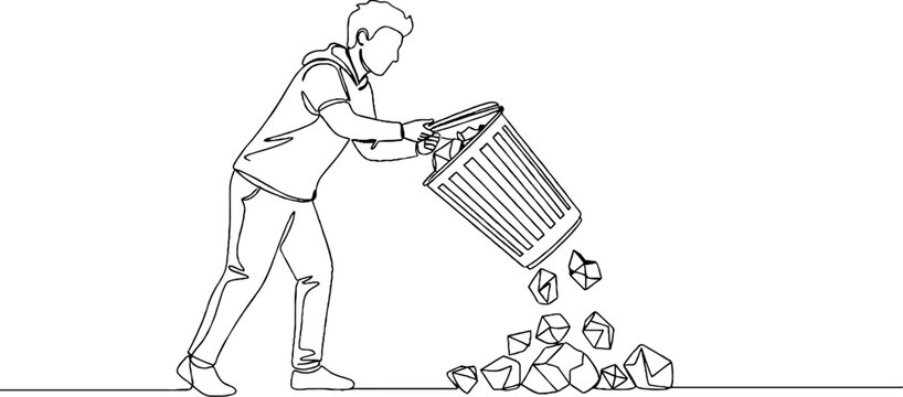 Person throwing trash into garbage bin outdoors.