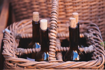 Fototapeta premium Three bottles of wine in a woven wicker basket