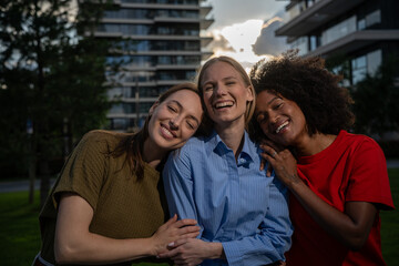 Young multiracial women having fun outdoor - Diverse female friends hugging each other during summer vacations at city © Nenad